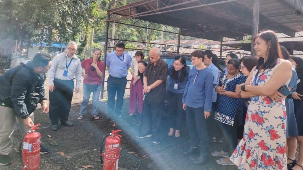 Team members focused and engaged during the fire safety briefing.