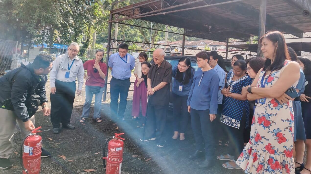 Team members focused and engaged during the fire safety briefing.